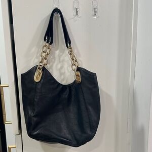 Michael Kor’s Butter Soft Black Women's Shoulder Bag with Gold Chain Detail